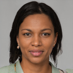 Joyful black young-adult female with medium  brown hair and brown eyes