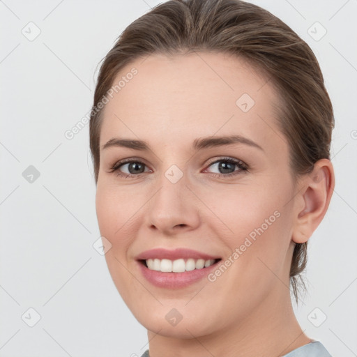 Joyful white young-adult female with medium  brown hair and grey eyes