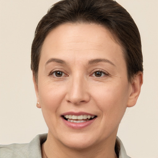 Joyful white adult female with short  brown hair and brown eyes