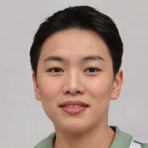 Joyful asian young-adult female with short  brown hair and brown eyes