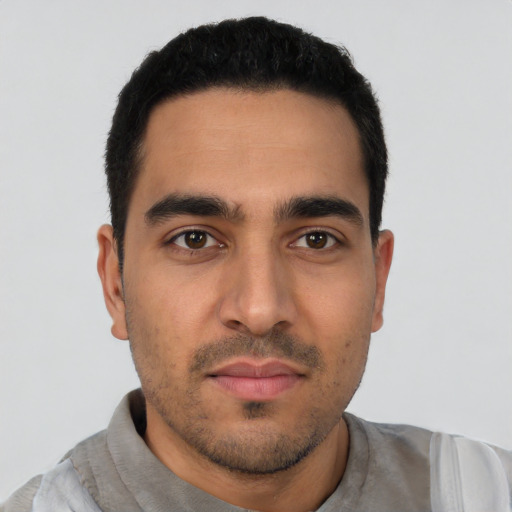 Neutral latino young-adult male with short  black hair and brown eyes