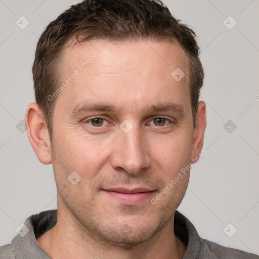 Joyful white adult male with short  brown hair and grey eyes