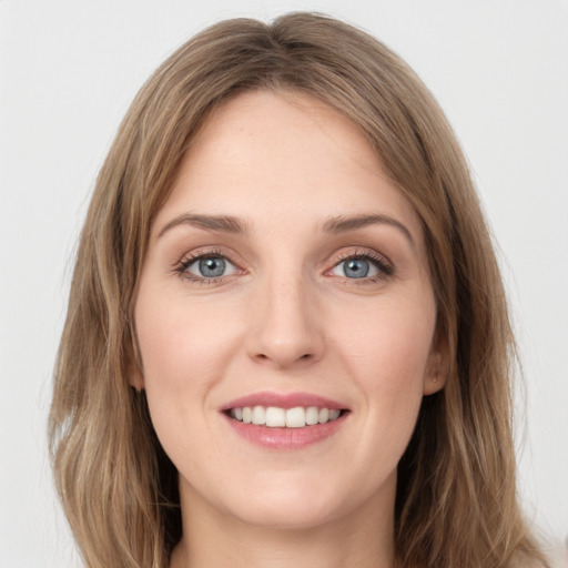 Joyful white young-adult female with long  brown hair and green eyes