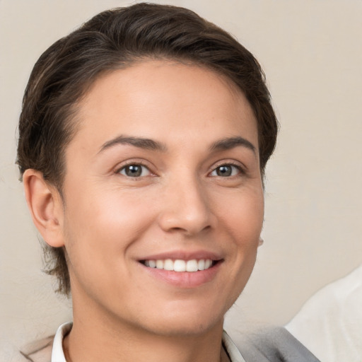 Joyful white young-adult female with short  brown hair and brown eyes