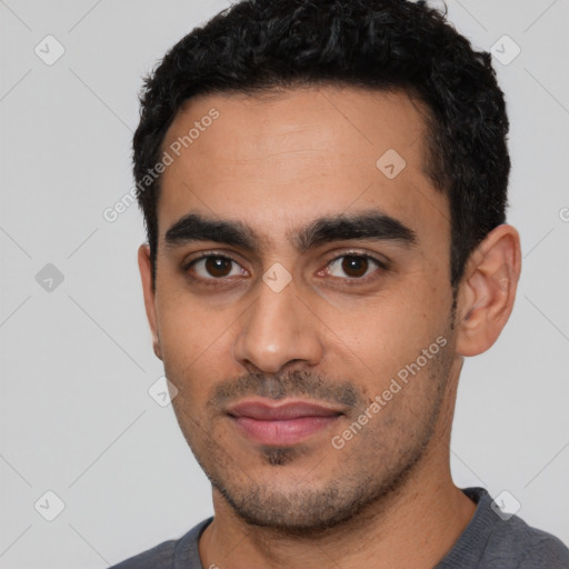 Joyful latino young-adult male with short  black hair and brown eyes