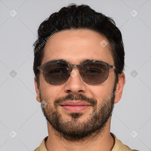 Joyful white young-adult male with short  black hair and brown eyes