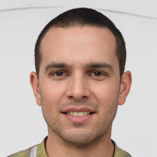 Joyful white young-adult male with short  brown hair and brown eyes