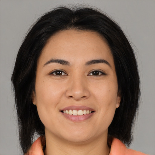 Joyful asian young-adult female with medium  brown hair and brown eyes