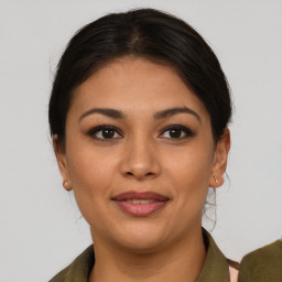 Joyful latino young-adult female with short  brown hair and brown eyes