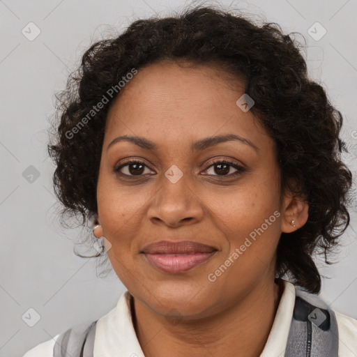 Joyful black adult female with medium  brown hair and brown eyes