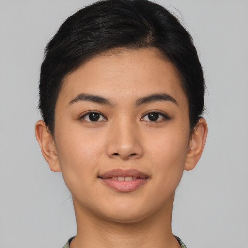 Joyful asian young-adult female with short  brown hair and brown eyes