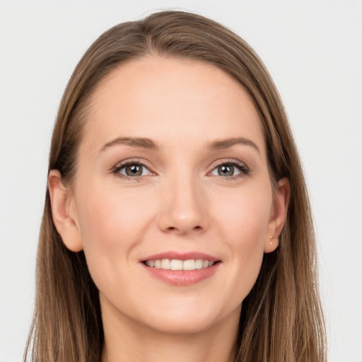 Joyful white young-adult female with long  brown hair and grey eyes