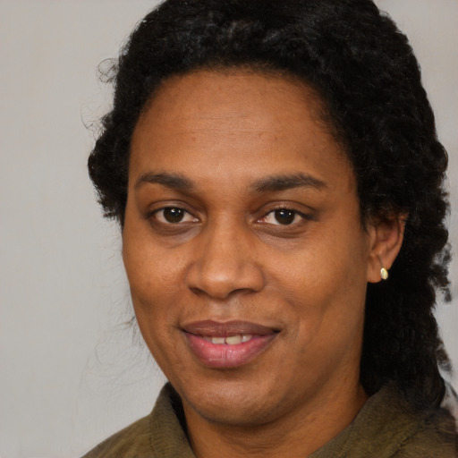 Joyful black adult female with medium  black hair and brown eyes