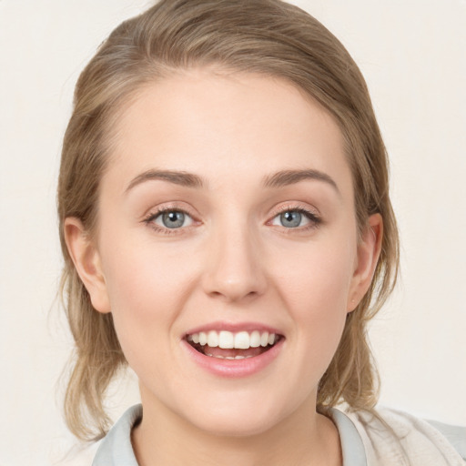 Joyful white young-adult female with medium  brown hair and blue eyes