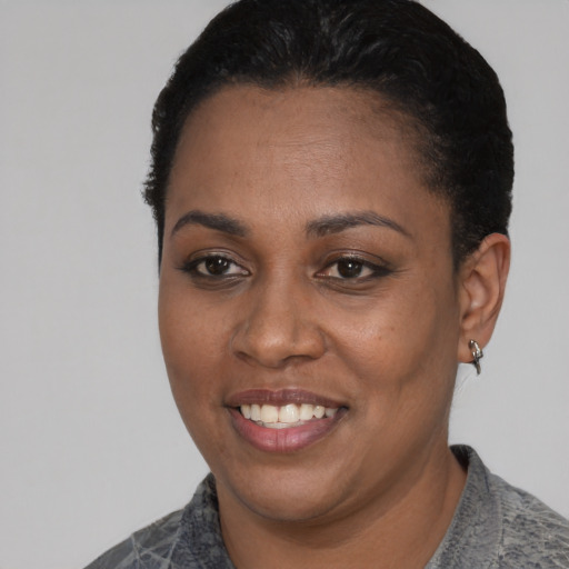 Joyful black young-adult female with short  black hair and brown eyes