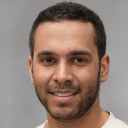 Joyful white young-adult male with short  black hair and brown eyes