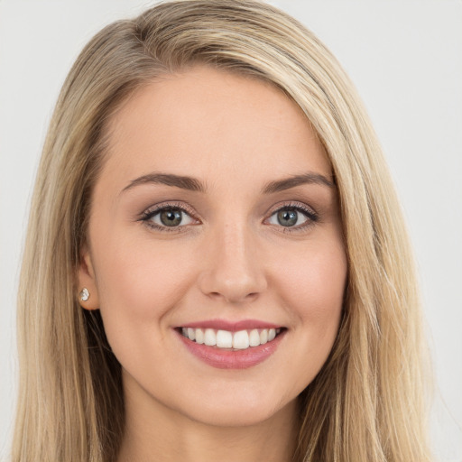 Joyful white young-adult female with long  brown hair and green eyes