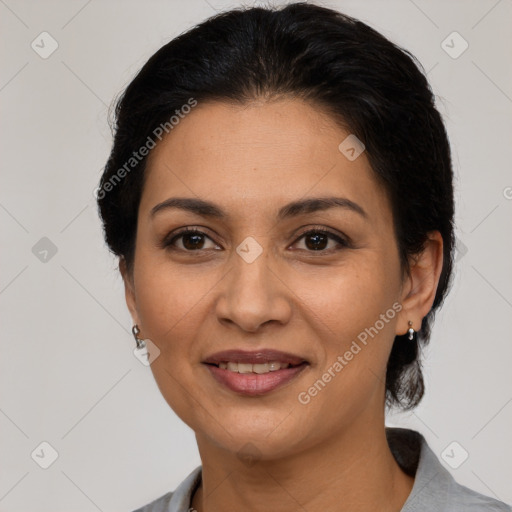 Joyful latino adult female with medium  brown hair and brown eyes