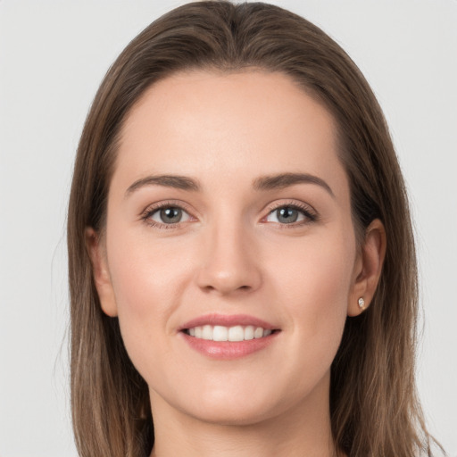 Joyful white young-adult female with long  brown hair and grey eyes