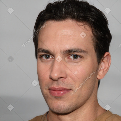 Joyful white adult male with short  brown hair and brown eyes