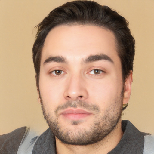 Joyful white young-adult male with short  black hair and brown eyes