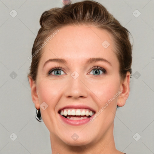 Joyful white young-adult female with short  brown hair and blue eyes