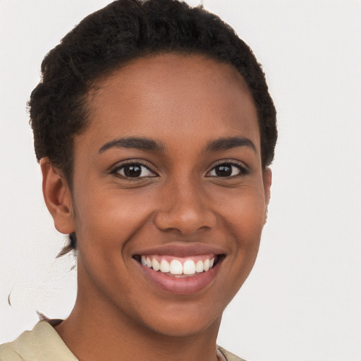 Joyful black young-adult female with short  brown hair and brown eyes