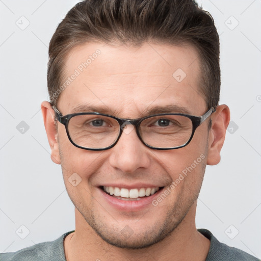 Joyful white young-adult male with short  brown hair and grey eyes