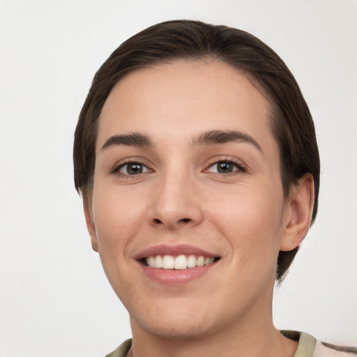 Joyful white young-adult female with short  brown hair and grey eyes