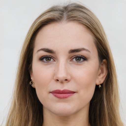 Joyful white young-adult female with long  brown hair and green eyes