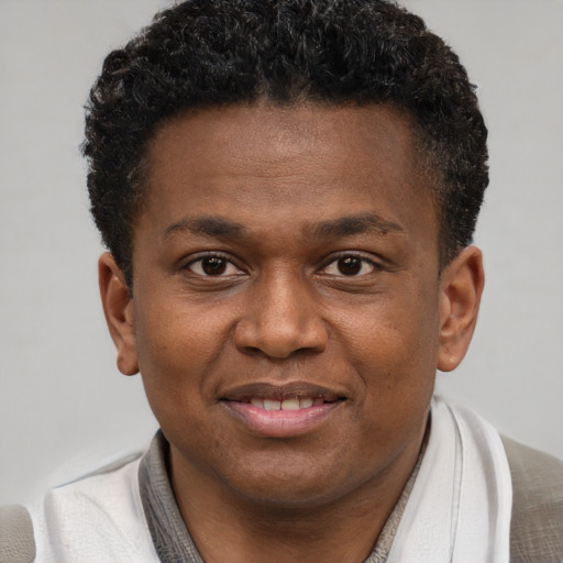 Joyful latino young-adult male with short  brown hair and brown eyes