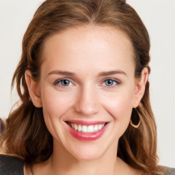 Joyful white young-adult female with long  brown hair and blue eyes