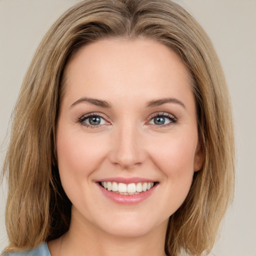 Joyful white young-adult female with medium  brown hair and green eyes