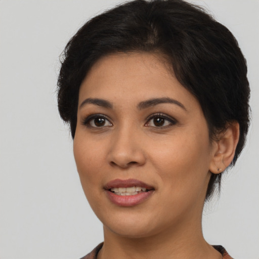 Joyful latino young-adult female with short  brown hair and brown eyes