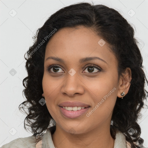 Joyful black young-adult female with long  brown hair and brown eyes