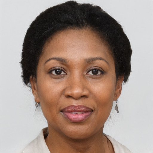Joyful black adult female with short  brown hair and brown eyes