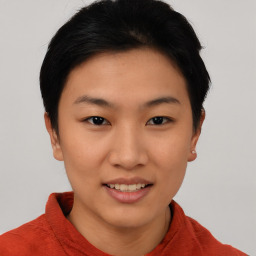 Joyful asian young-adult female with short  black hair and brown eyes