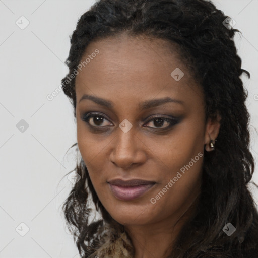 Joyful black young-adult female with long  black hair and brown eyes