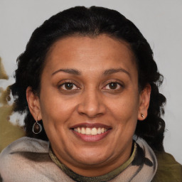 Joyful black adult female with medium  brown hair and brown eyes