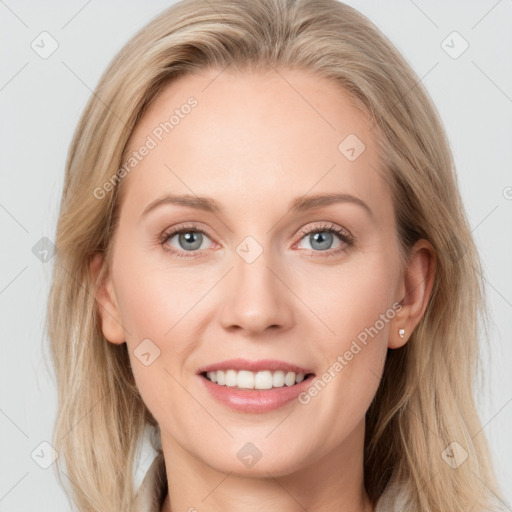 Joyful white young-adult female with long  brown hair and blue eyes