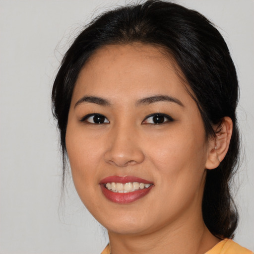 Joyful asian young-adult female with medium  black hair and brown eyes