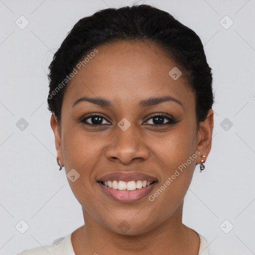 Joyful black young-adult female with short  black hair and brown eyes