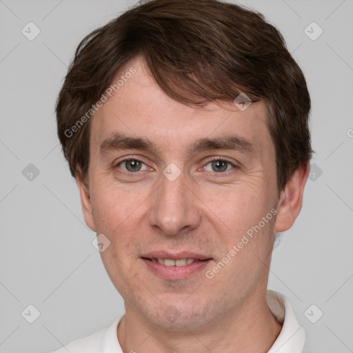 Joyful white adult male with short  brown hair and grey eyes