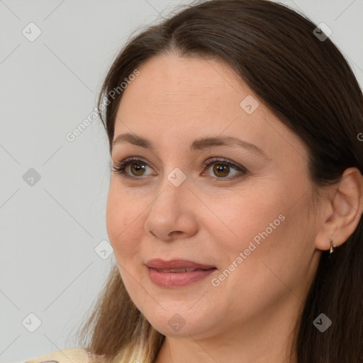 Joyful white adult female with long  brown hair and brown eyes