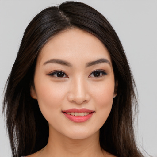 Joyful asian young-adult female with long  brown hair and brown eyes