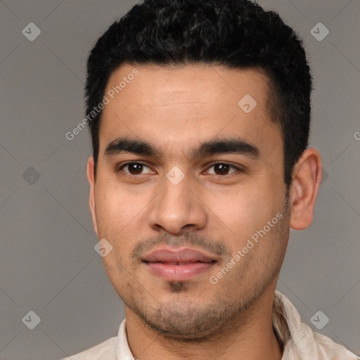 Joyful latino young-adult male with short  black hair and brown eyes