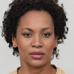 Joyful black adult female with short  brown hair and brown eyes