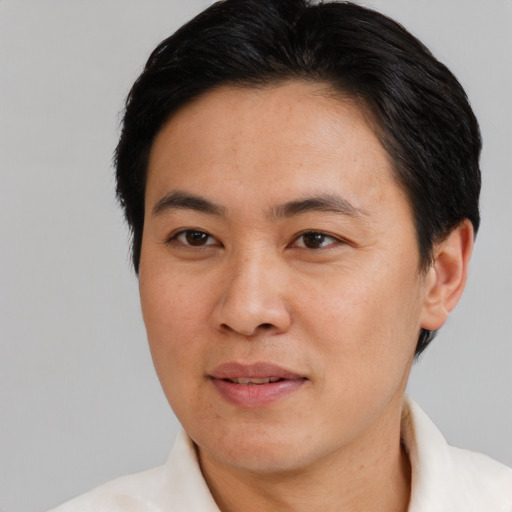Joyful white adult male with short  black hair and brown eyes