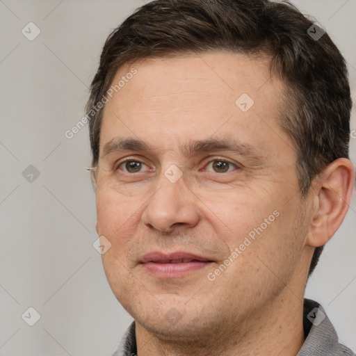 Joyful white adult male with short  brown hair and brown eyes