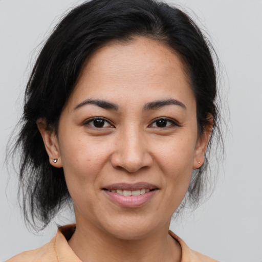 Joyful asian adult female with medium  brown hair and brown eyes
